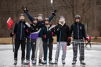 Students holding shovels as they prepare to play hockey. Links to Gifts by Estate Note